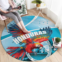 Round blue macaw graphic rug with “HONDURAS” lettering and small star details