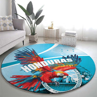 Round blue rug featuring a scarlet macaw, “HONDURAS” text, and blue bird artwork