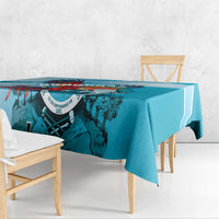 Teal-blue printed tablecloth with border stripe and central emblem graphic