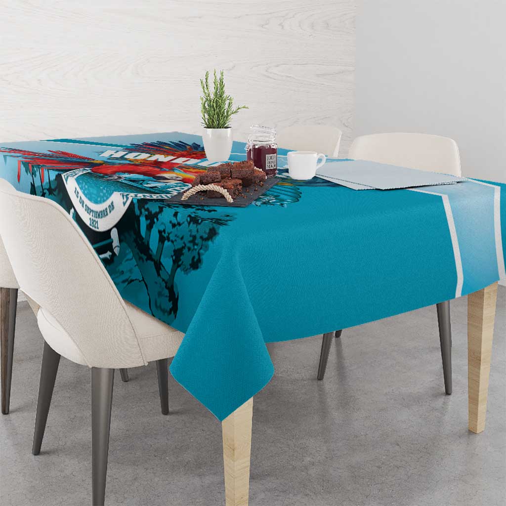 Teal-blue tablecloth with central crest, birds, and blue-toned landscape print
