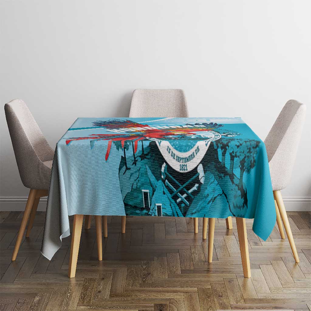 Teal-blue printed tablecloth with colorful top border and central coat-of-arms graphic