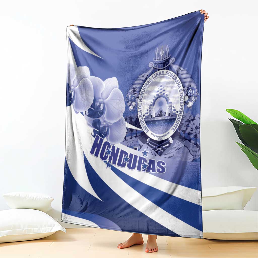 Blue and white Honduras blanket with orchid flower artwork and circular coat of arms emblem