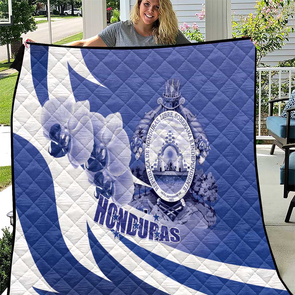 Blue and white Honduras quilt blanket with crest and lion graphic