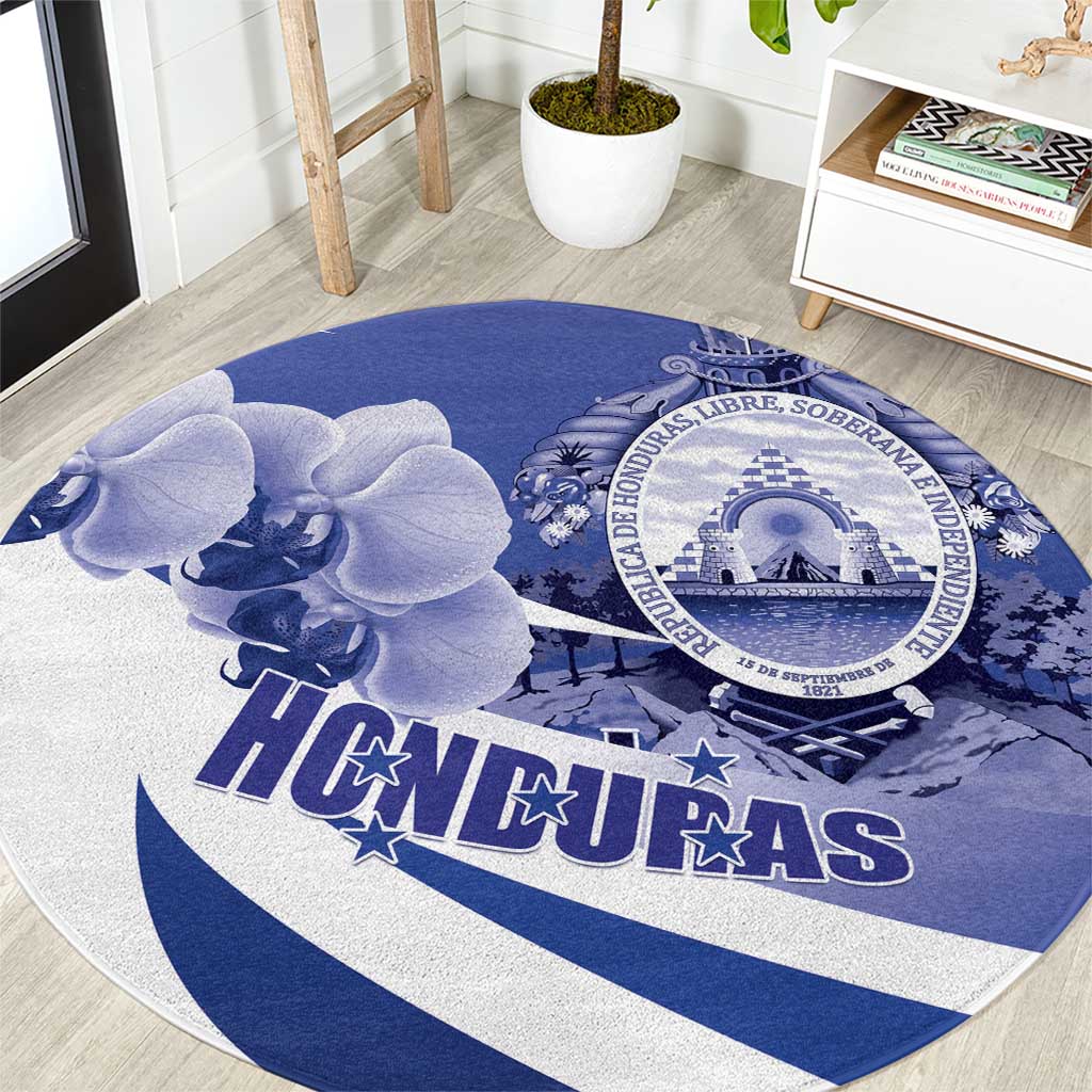 Round navy-and-white Honduras rug with large emblem, orchids, and bold HONDURAS text