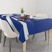 Navy blue tablecloth with white diagonal stripes on a dining table with chairs