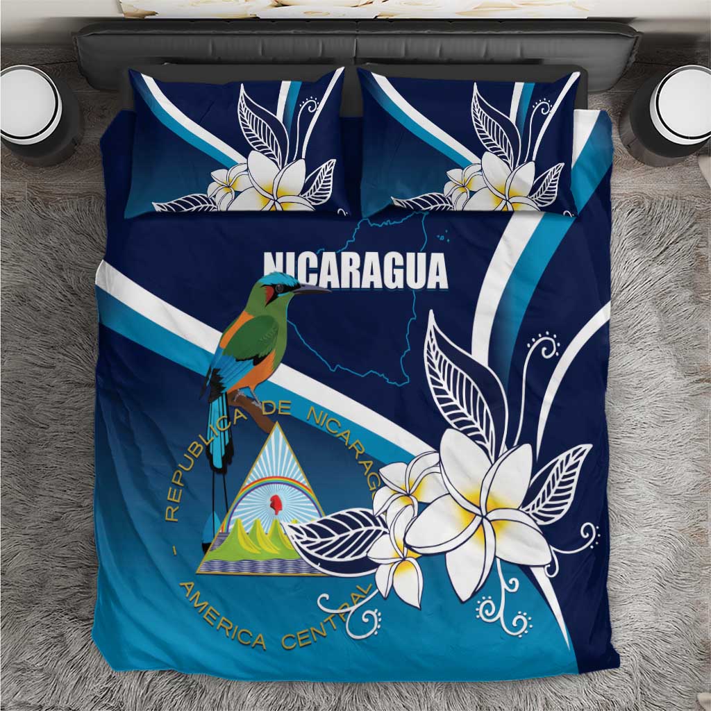Blue Nicaragua Independence bedding set with bird, plumeria flowers, and flag stripes