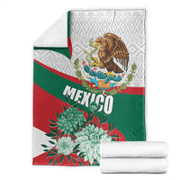 Folded Mexico-themed blanket with green-red-white stripes, eagle crest, and floral print