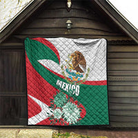 Mexico-themed quilt hanging outdoors with eagle crest, “Mexico” wordmark, and teal flower accents