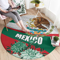 Round Mexican rug showing “MEXICO” lettering, eagle, cactus flowers, and red-green stripes