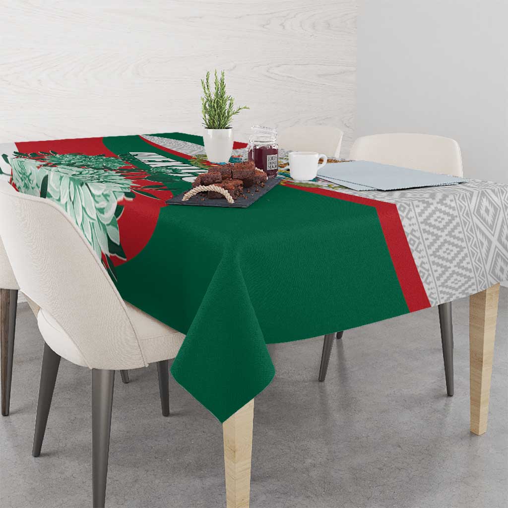 Tablecloth with green base, red border, white floral pattern, and eagle graphic