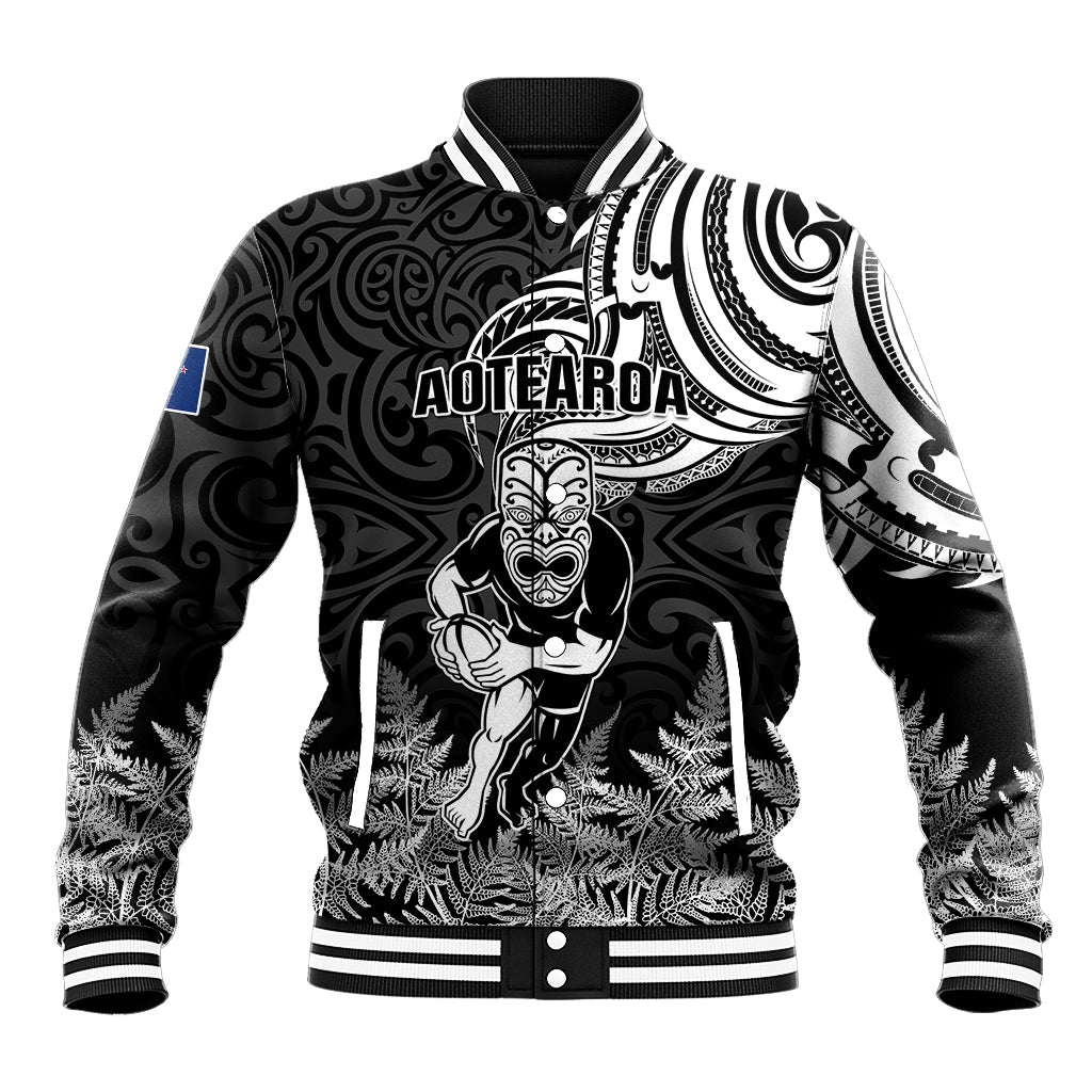 Black rugby-style baseball jacket with tiki and tribal Maori graphic, striped collar