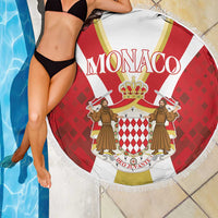 Round red Monaco beach blanket with crown crest, white fringed edge