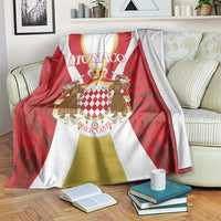 Red and white Monaco print blanket with gold stripes and crest design