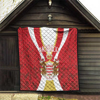 Red Monaco quilt hanging display with quilted diamond texture, crest emblem and white-gold stripe