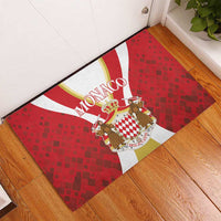 Red rubber doormat with Monaco crest and horsemen, bordered by white and gold stripes