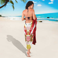 Red Monaco sarong shown from behind, with printed crest and curved stripes