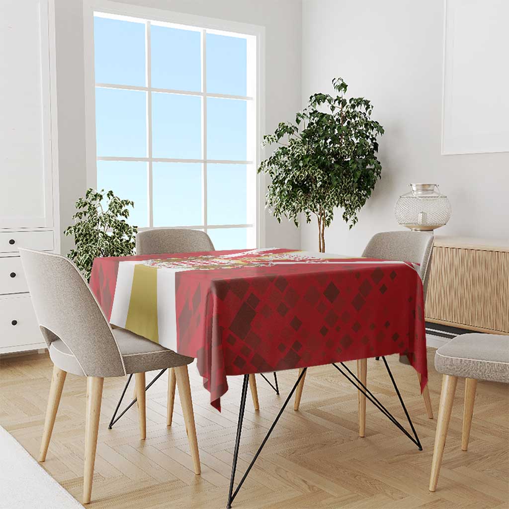 Red tablecloth with geometric diamond and banner stripe pattern, draped over dining table