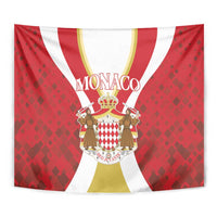 Red Monaco tapestry close-up with crown crest, MONACO text, and striped arches