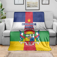 Central African Republic flag-style blanket on gray sofa, full crest centered