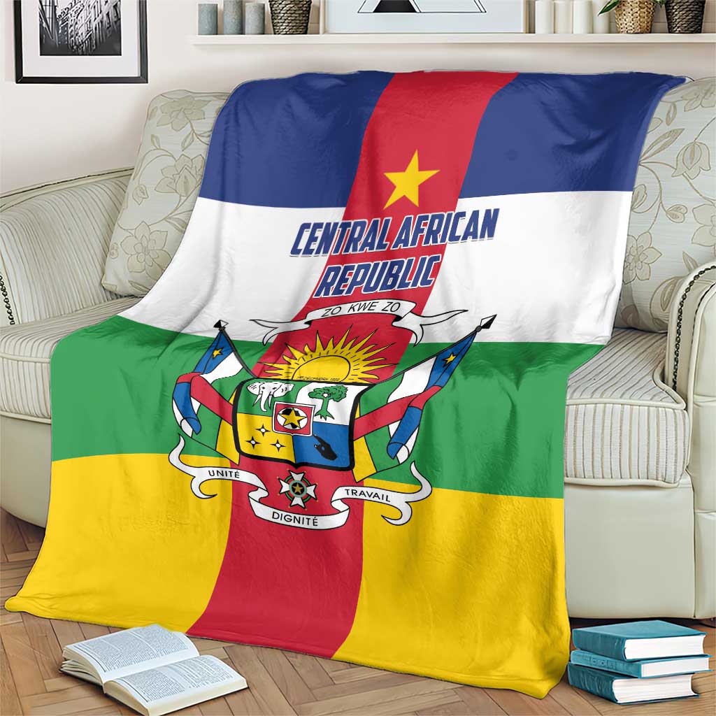 Central African Republic flag-style blanket on beige couch, crest and motto centered