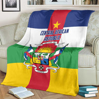 Central African Republic flag-style blanket on beige couch, crest and motto centered