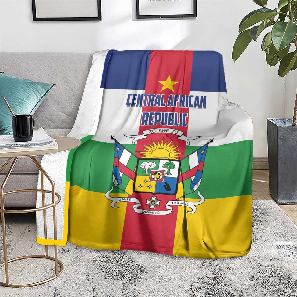 Central African Republic flag-style blanket on gray sofa, green red yellow panels with crest