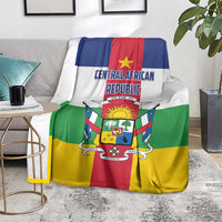 Central African Republic flag-style blanket on gray sofa, green red yellow panels with crest