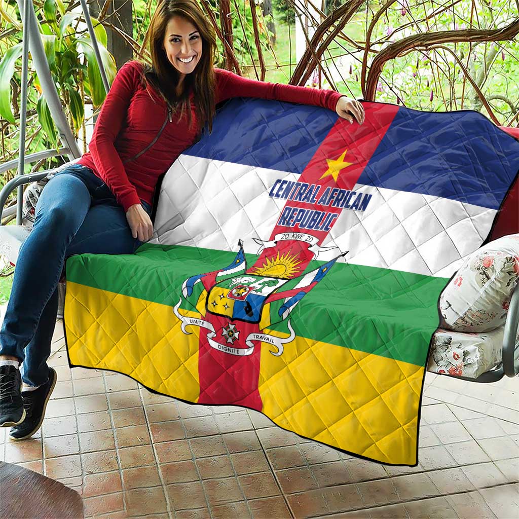 Central African Republic flag quilt held up, quilted diamond pattern with flag crest in red and gold