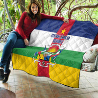Central African Republic flag quilt held up, quilted diamond pattern with flag crest in red and gold