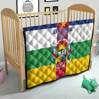 Central African Republic flag quilt on baby bed, quilted diamonds with central crest and stripes