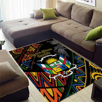 Rectangular black area rug with vibrant geometric pattern and central crest graphic