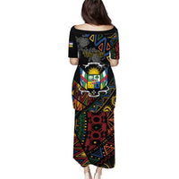 Black long dress, back view, Central African Republic emblem on geometric African pattern