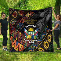 Black quilt blanket with Central African crest in center and colorful swirling geometric tribal design