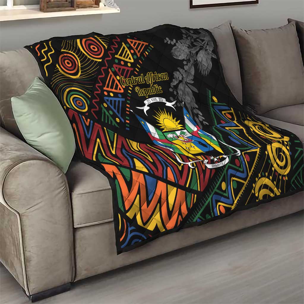 Black quilt blanket on sofa with Central African crest and colorful geometric tribal pattern