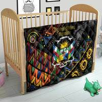 Black quilt blanket on crib with Central African crest emblem and colorful swirling geometric tribal design