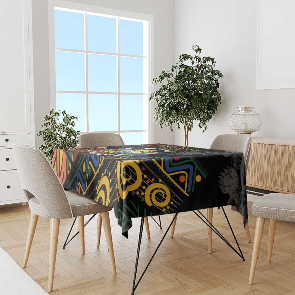 Black rectangular tablecloth with bold multicolor African geometric pattern on dining table.
