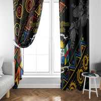 Pair of black window curtains with colorful geometric crest on left and floral on right