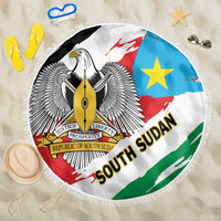 Round South Sudan flag beach blanket with fringed edge, eagle crest, blue star, red shield