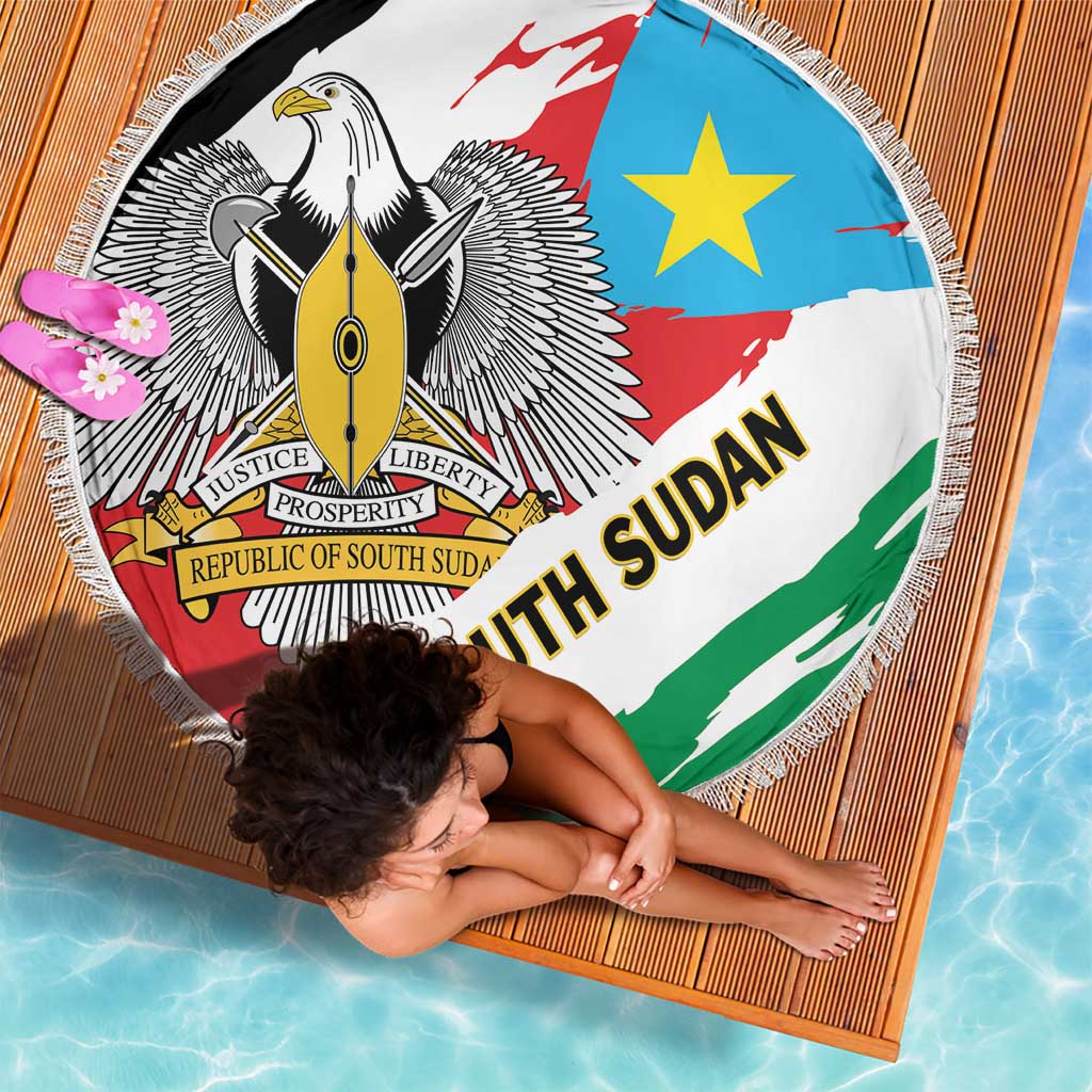 Round South Sudan flag beach blanket with fringed border, eagle emblem and green ribbon stripe