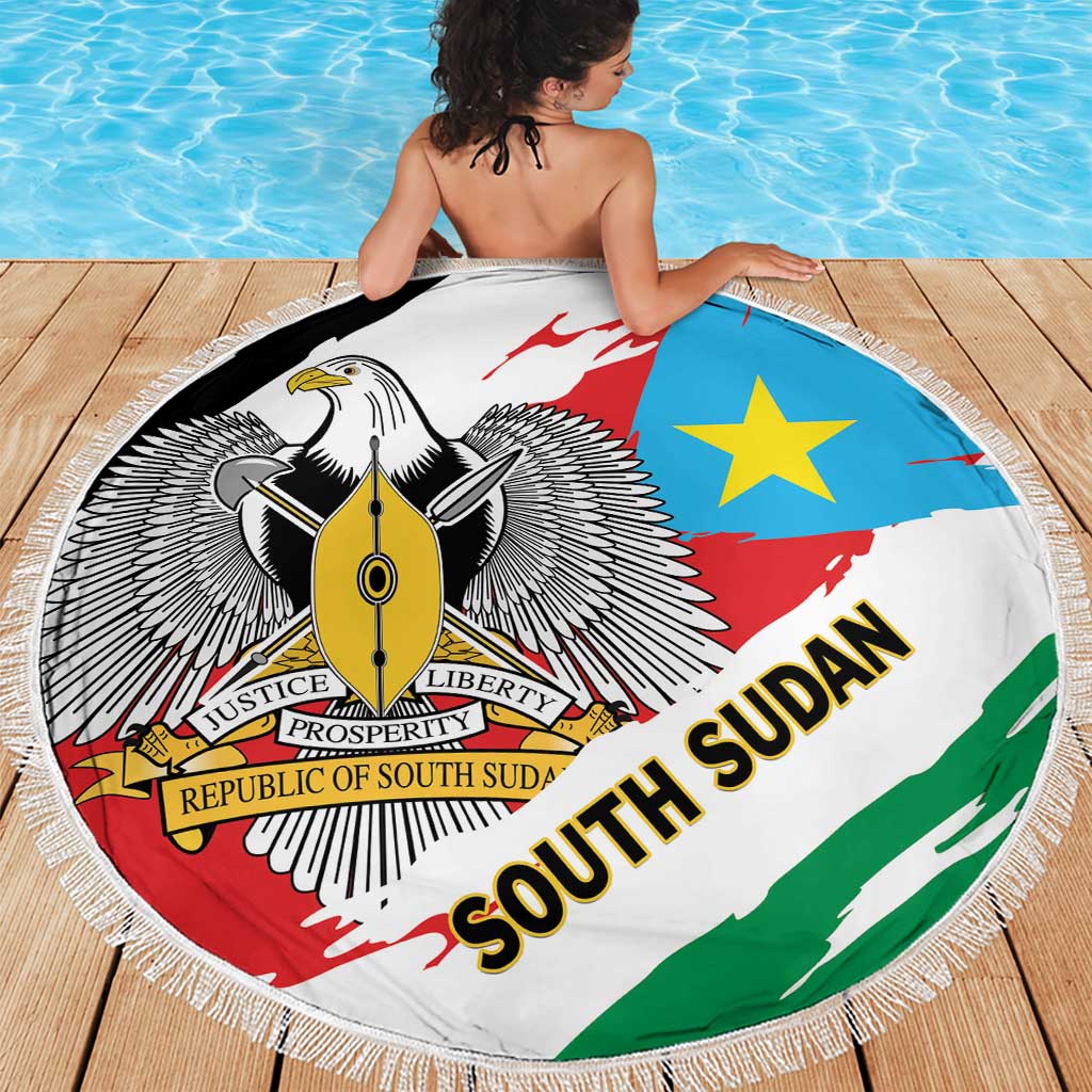 Round South Sudan flag beach blanket, fringed border, eagle emblem and star on blue field