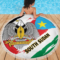 Round South Sudan flag beach blanket, fringed border, eagle emblem and star on blue field