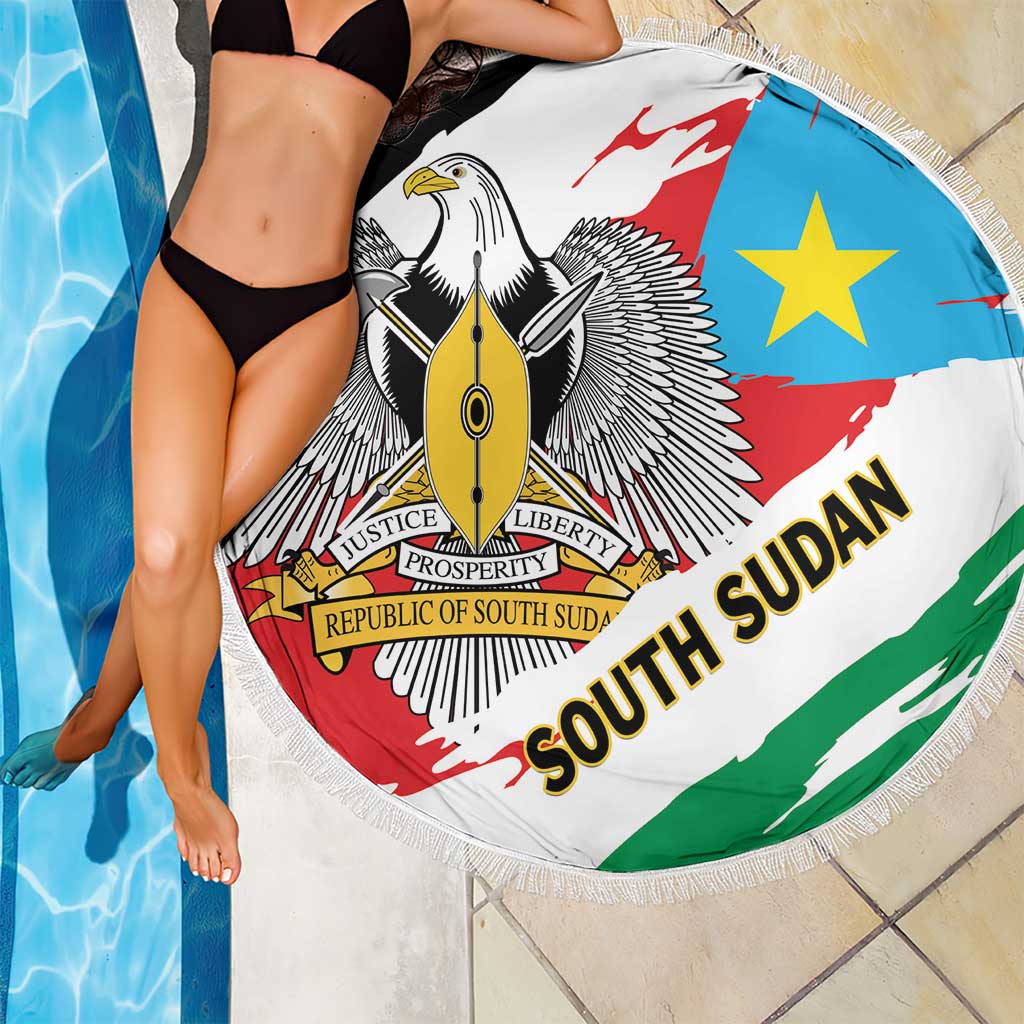 Round South Sudan flag beach blanket with fringed edge and blue, red, white, green design