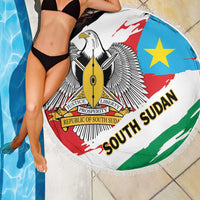 Round South Sudan flag beach blanket with fringed edge and blue, red, white, green design