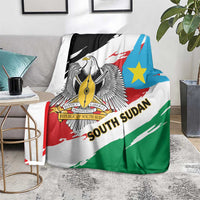 Flag-themed blanket over sofa with eagle emblem, blue star, and diagonal red-green stripes