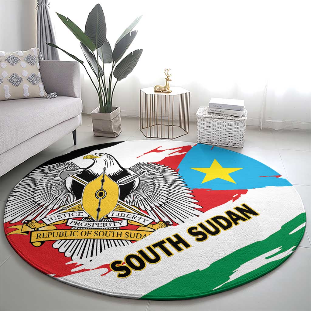 Round area rug with South Sudan flag colors, winged emblem, blue star, and bold “SOUTH SUDAN”