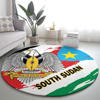 Round area rug with South Sudan flag colors, winged emblem, blue star, and bold “SOUTH SUDAN”