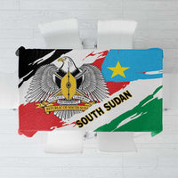 South Sudan flag grunge tablecloth folded, green red blue with emblem and text