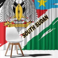 Close-up South Sudan flag-style curtain fabric, eagle emblem and text on black and green