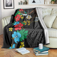 Black throw blanket draped on couch with eagle, hibiscus flowers, African geometric pattern