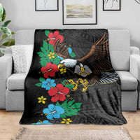 Black blanket on sofa with eagle graphic, hibiscus floral accents, African pattern